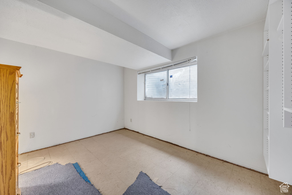 Empty room featuring tile patterned floors