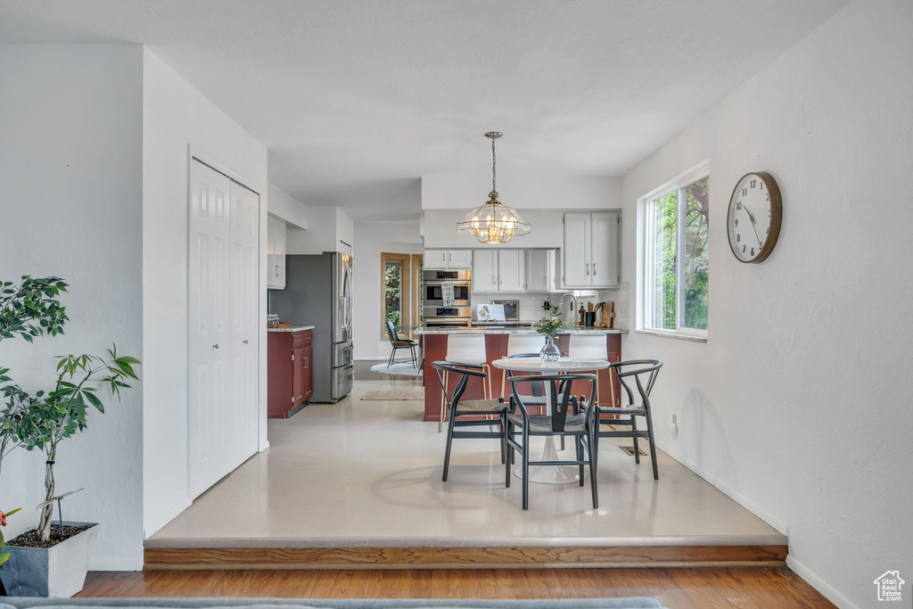 Dining space with baseboards and a chandelier