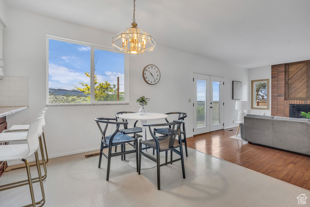 Dining room with a chandelier, a fireplace, and baseboards