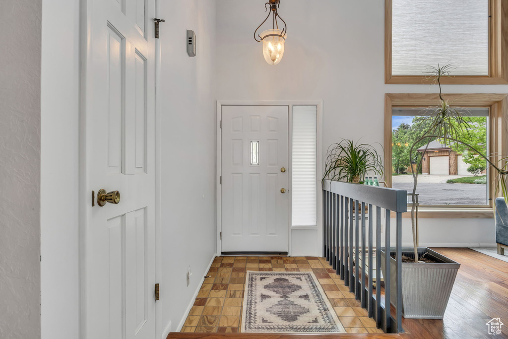 Foyer featuring a towering ceiling and baseboards