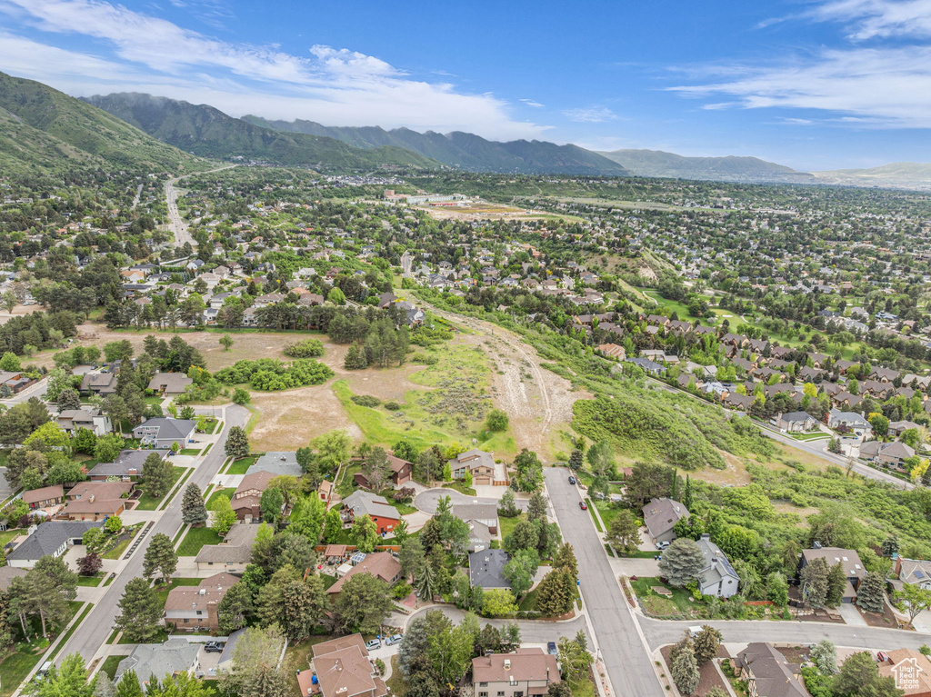 Aerial view of property's location with a mountain backdrop and nearby suburban area