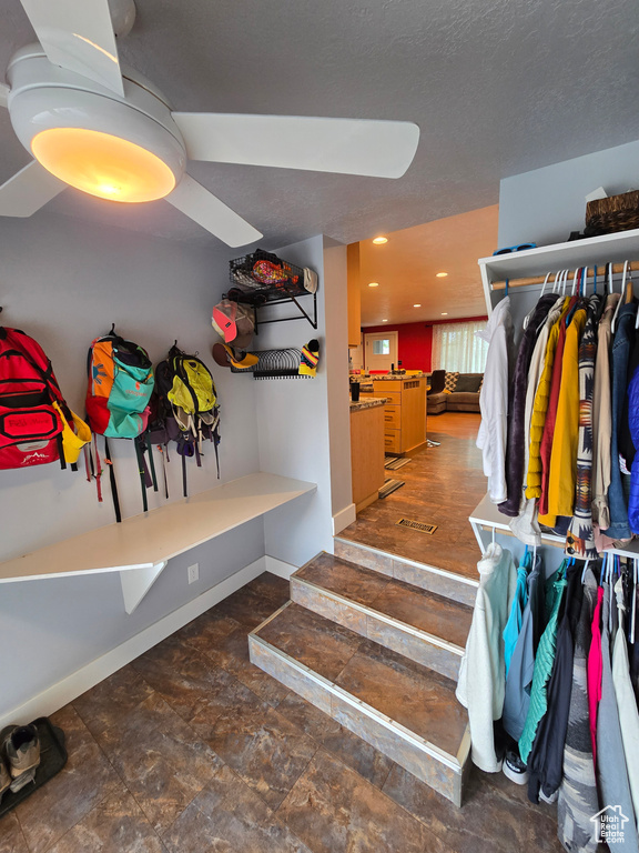 Mudroom with baseboards, recessed lighting, and stone finish floors
