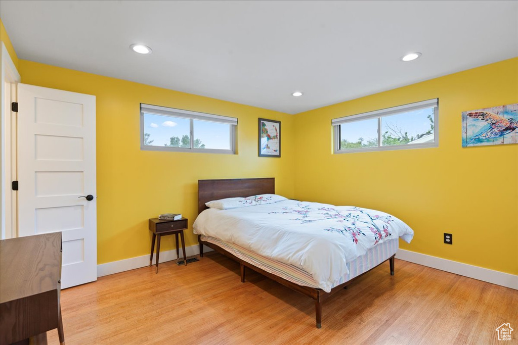 Bedroom featuring light wood finished floors, baseboards, and recessed lighting