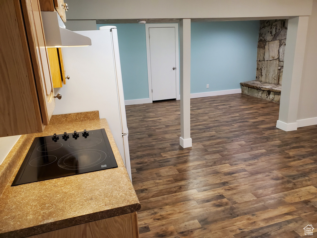 Finished basement with baseboards and dark wood finished floors