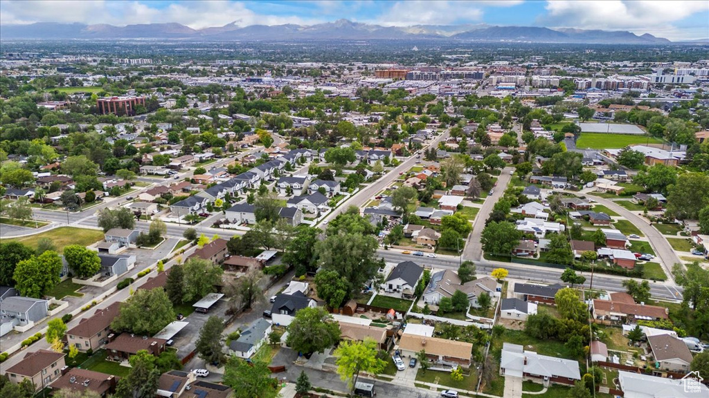 Aerial view of property\'s location featuring a mountain backdrop and nearby suburban area