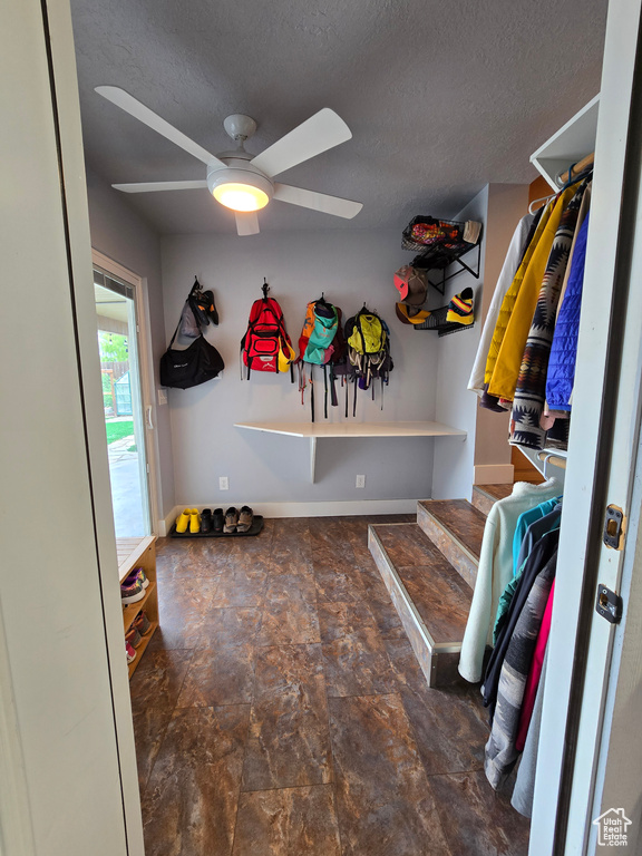 Mudroom featuring a ceiling fan, a textured ceiling, and baseboards