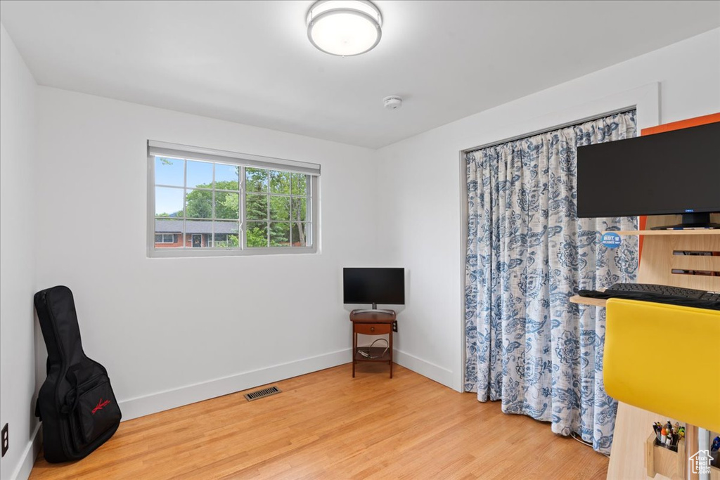 Office space with wood finished floors and baseboards