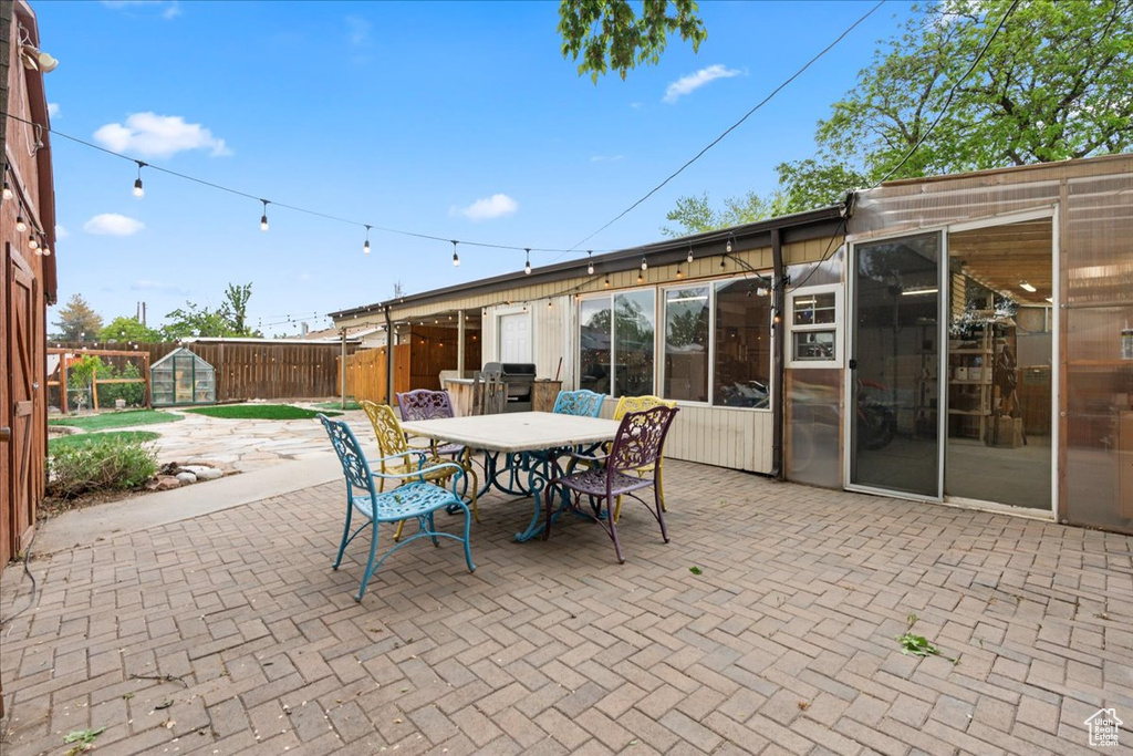 View of patio featuring fence and outdoor dining space