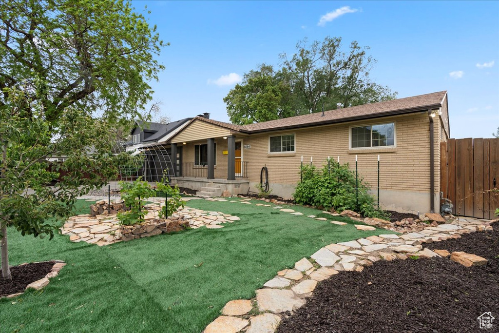 Back of house featuring brick siding