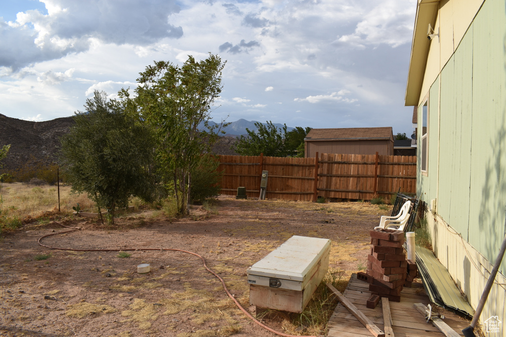 View of yard with a mountain view and fence