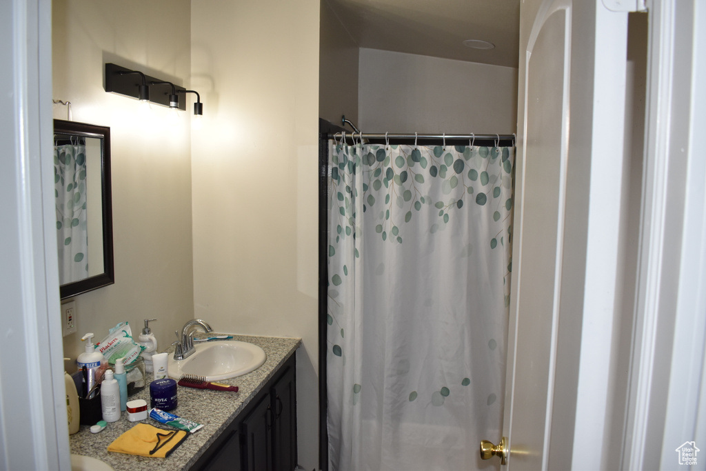 Full bathroom with vanity and a shower with curtain