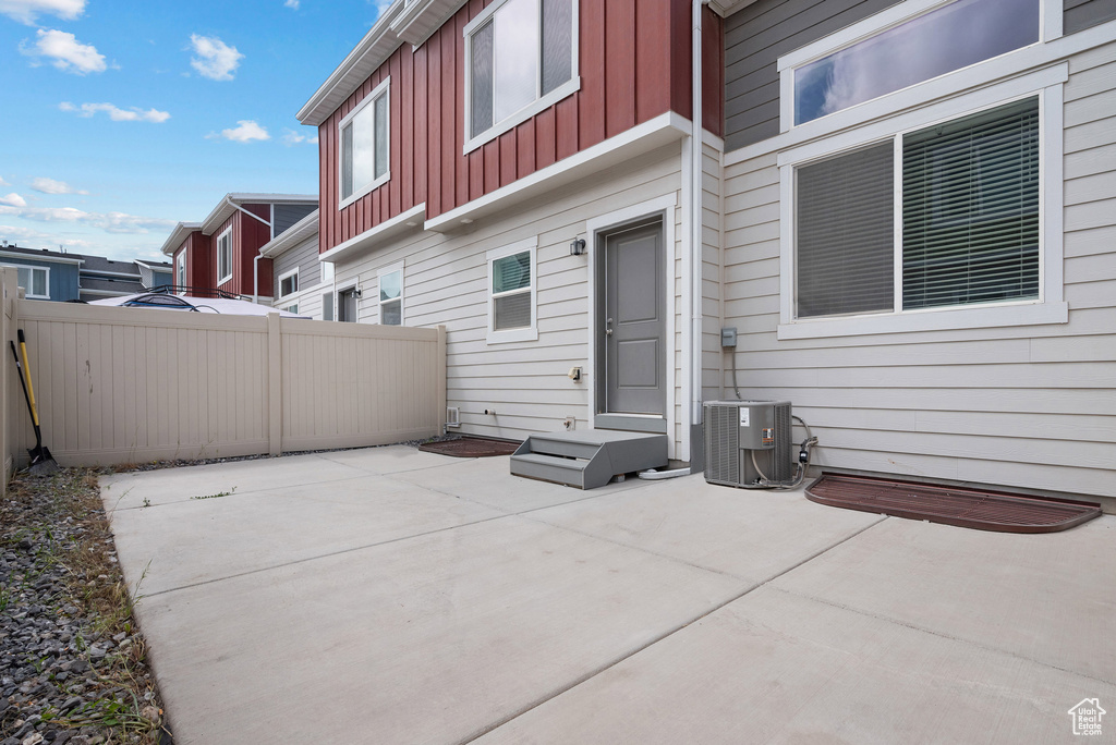 View of patio / terrace featuring central AC and fence