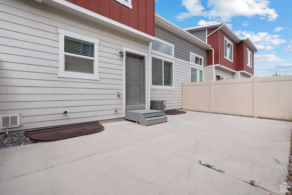 View of patio / terrace featuring fence and cooling unit