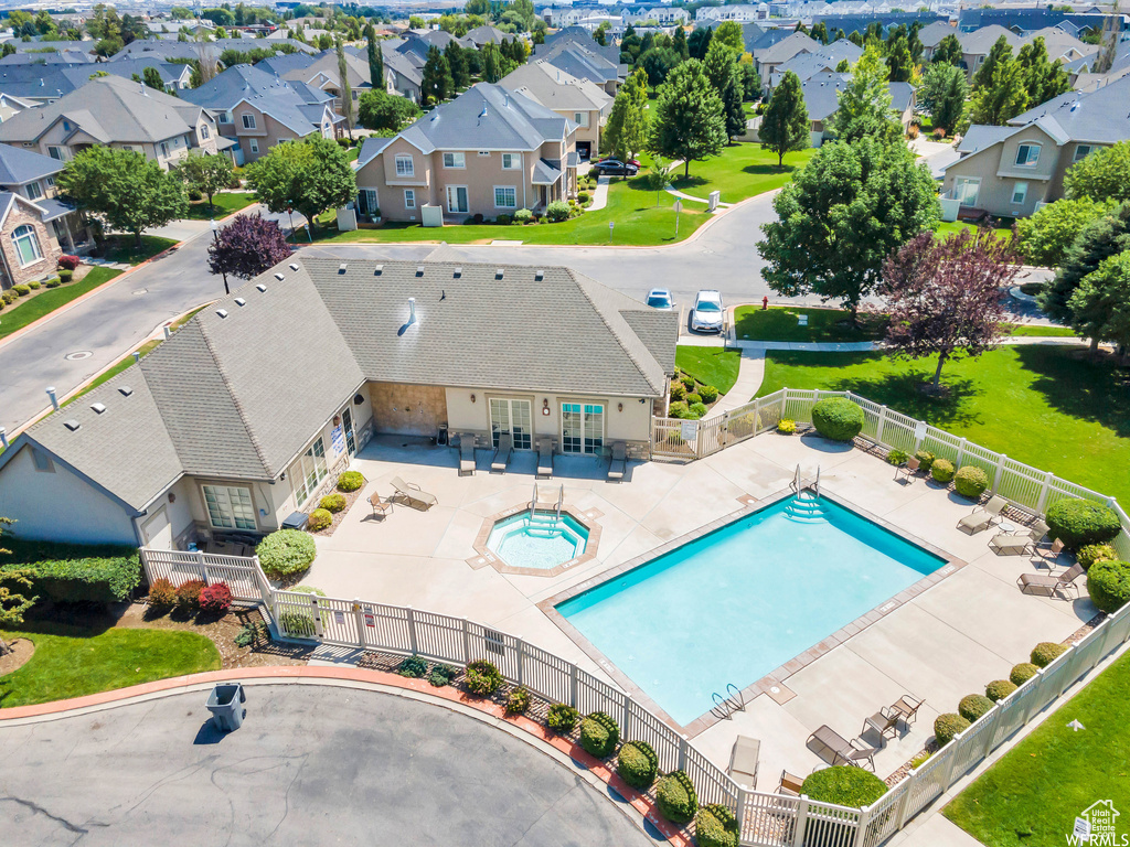 Aerial perspective of suburban area featuring a pool
