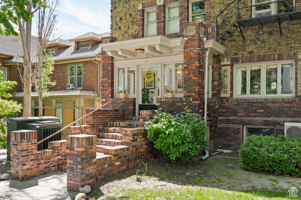 Doorway to property with brick siding