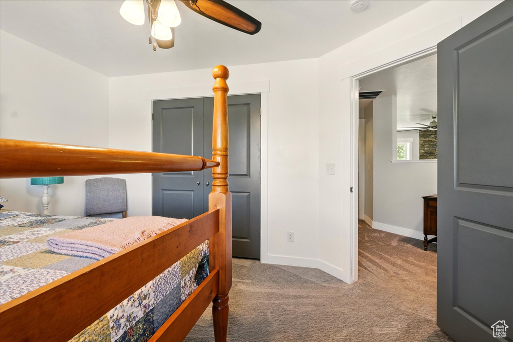 Carpeted bedroom with baseboards and ceiling fan