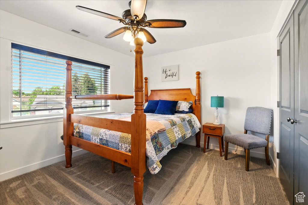 Bedroom featuring carpet, baseboards, and a closet