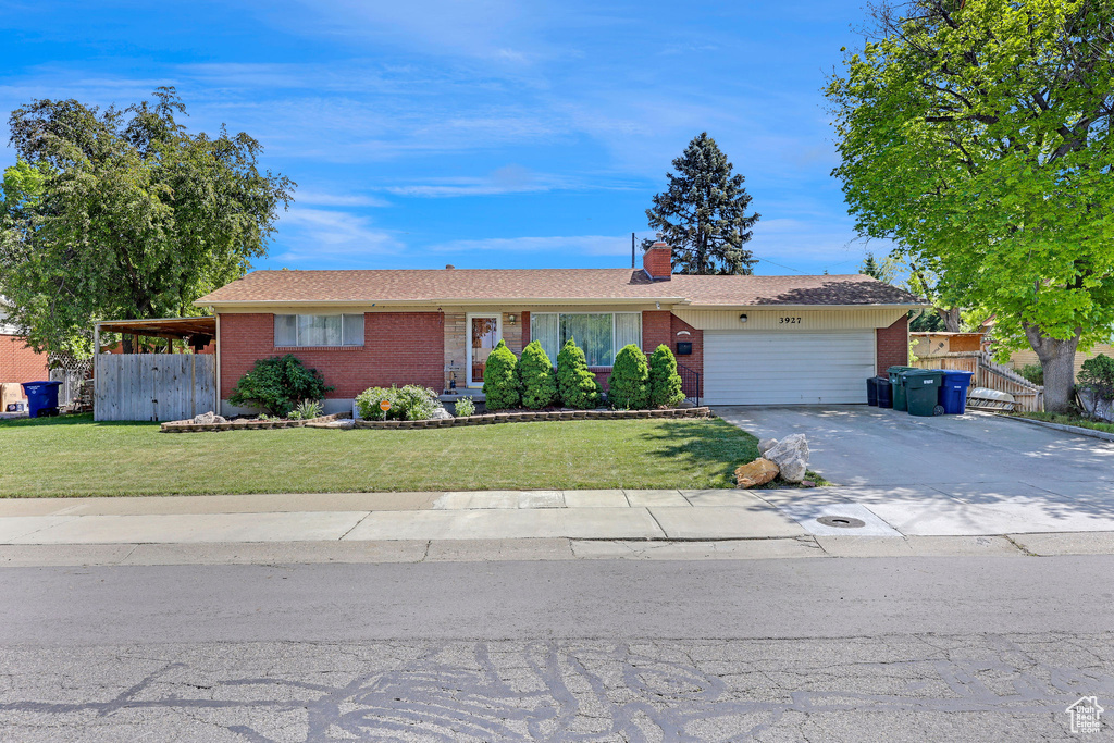 Ranch-style home with brick siding, concrete driveway, a garage, and a chimney