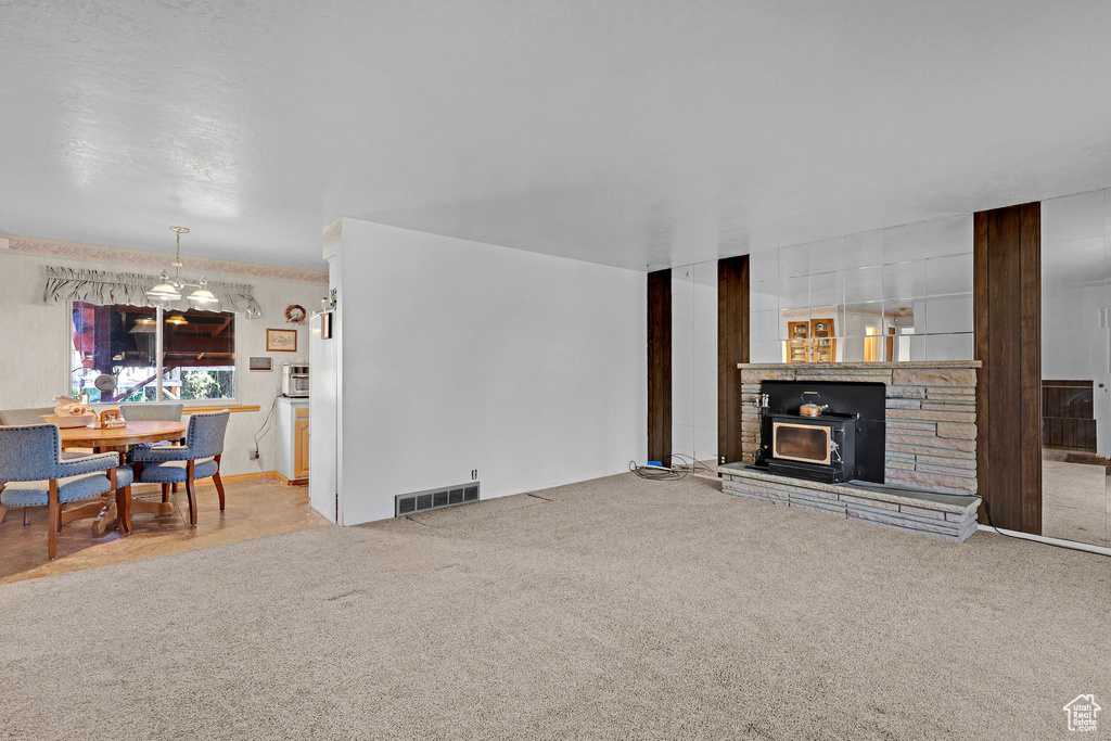 Living room featuring carpet and a fireplace