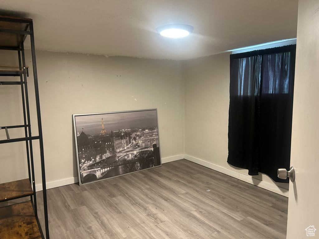 Empty room featuring wood finished floors and baseboards