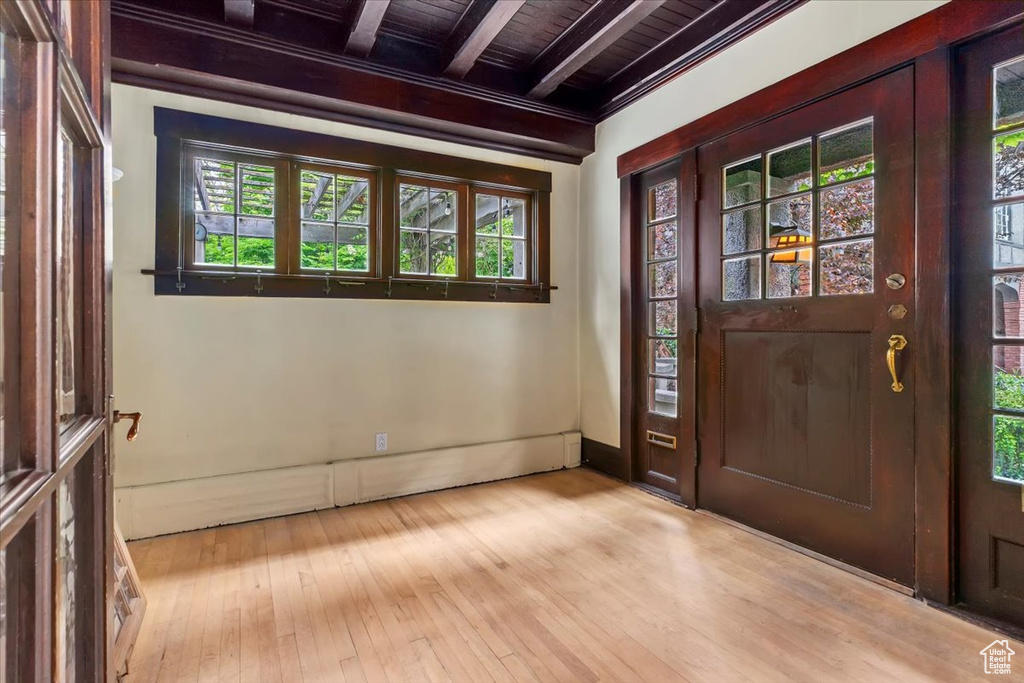 Entryway featuring beam ceiling, wooden ceiling, and light wood-style floors