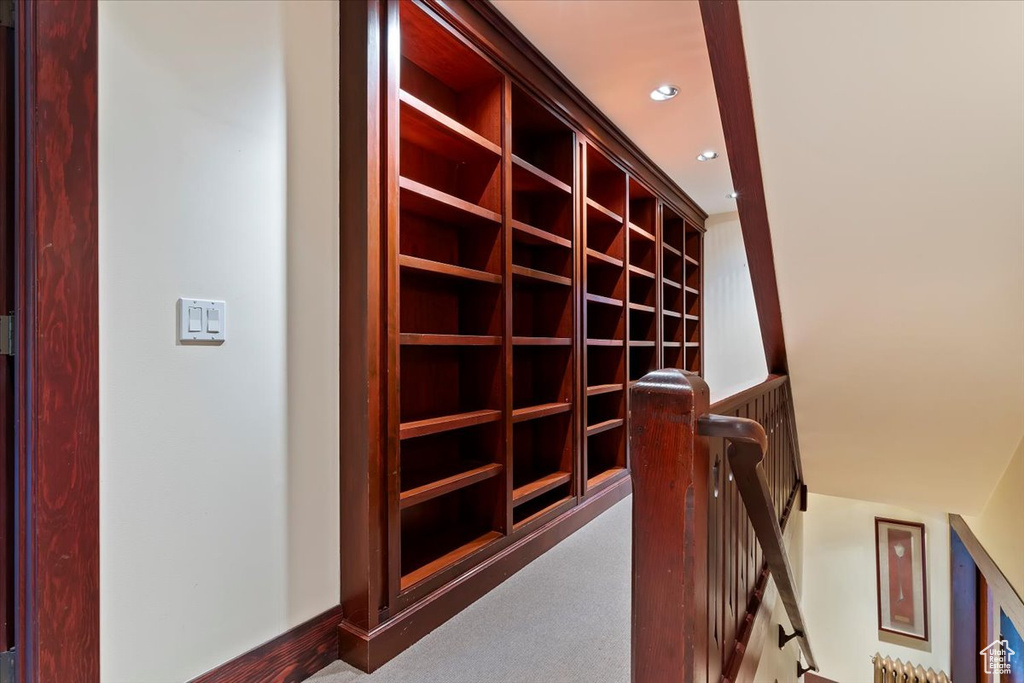 Hallway featuring an upstairs landing, carpet floors, and recessed lighting