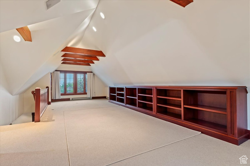 Additional living space featuring carpet flooring and lofted ceiling
