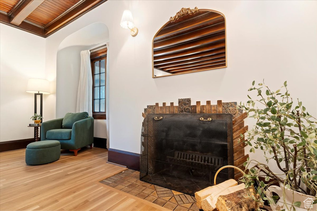 Detailed view of wood finished floors, baseboards, and arched walkways