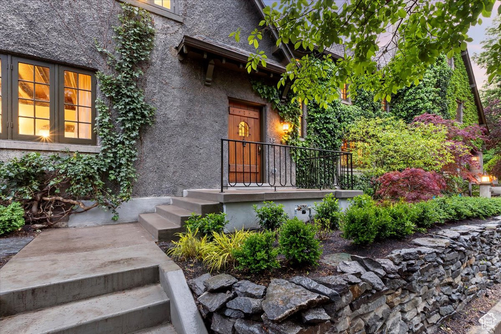 Entrance to property with stucco siding