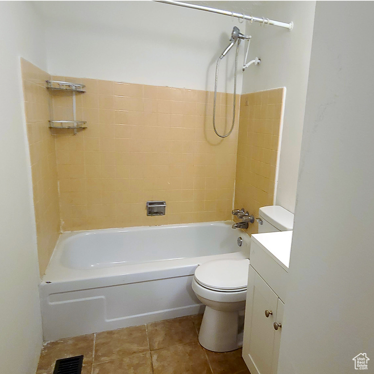 Full bathroom featuring toilet, tile patterned floors, shower / tub combination, and vanity