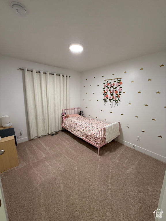 Bedroom with light carpet and baseboards