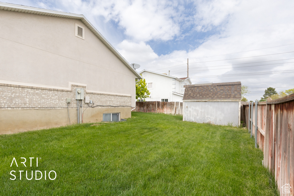 View of yard featuring a shed and an outdoor structure