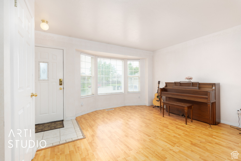 Entryway featuring wood finished floors and baseboards