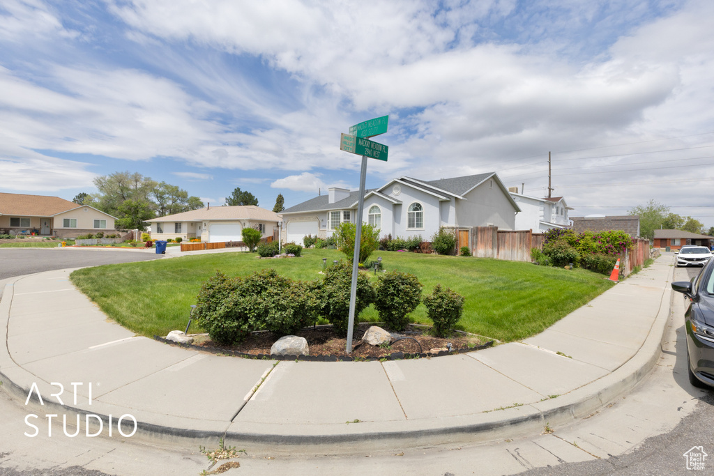 View of front facade with a residential view and a garage