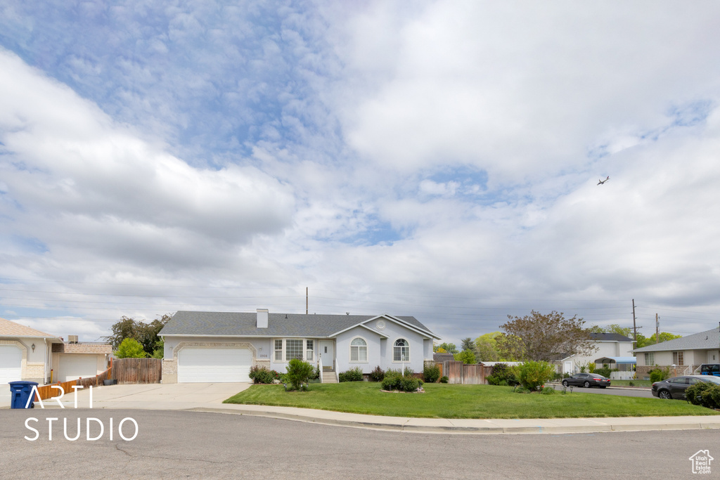 Ranch-style home featuring an attached garage and driveway