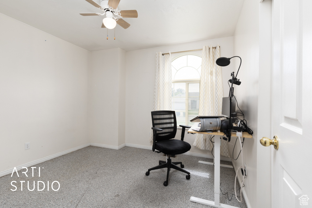 Home office featuring carpet floors, ceiling fan, and baseboards