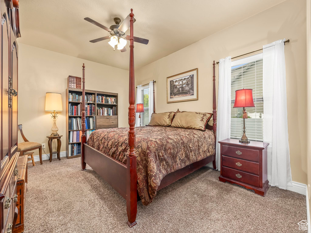 Carpeted bedroom featuring baseboards and a ceiling fan