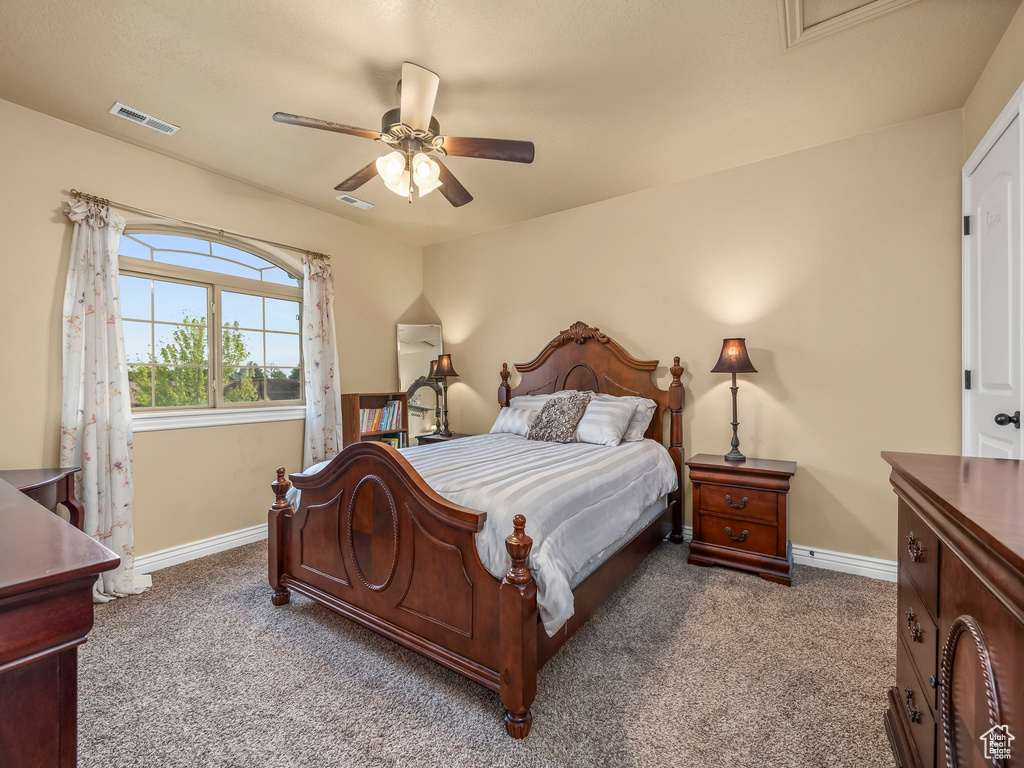 Bedroom featuring carpet floors, baseboards, and a ceiling fan