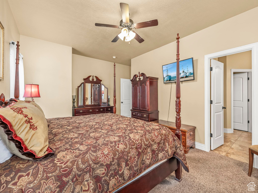 Carpeted bedroom featuring a ceiling fan