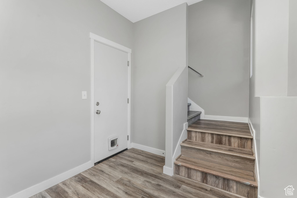 Staircase featuring wood finished floors and baseboards