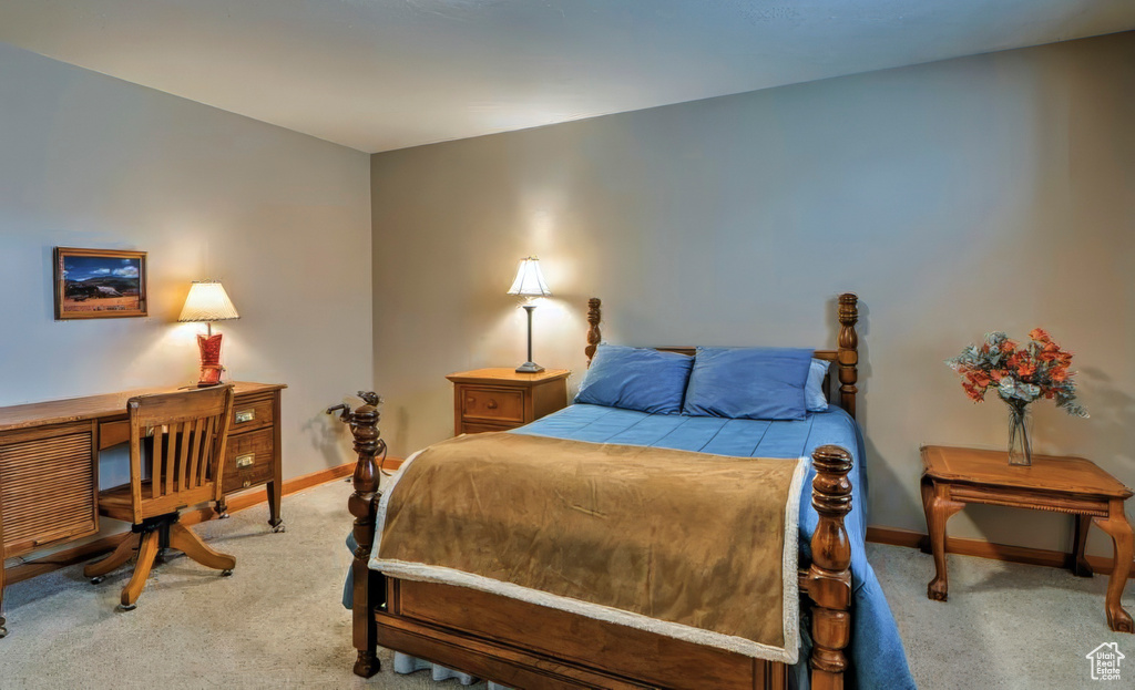 Bedroom featuring baseboards and carpet floors