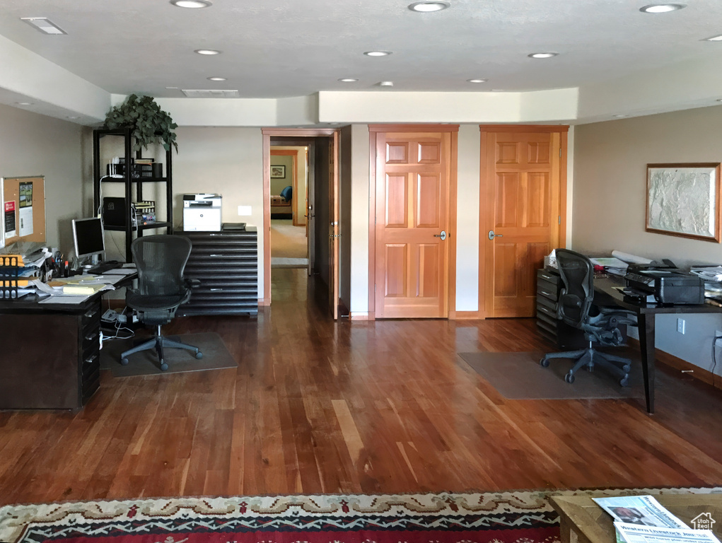 Office space with recessed lighting, visible vents, and wood finished floors