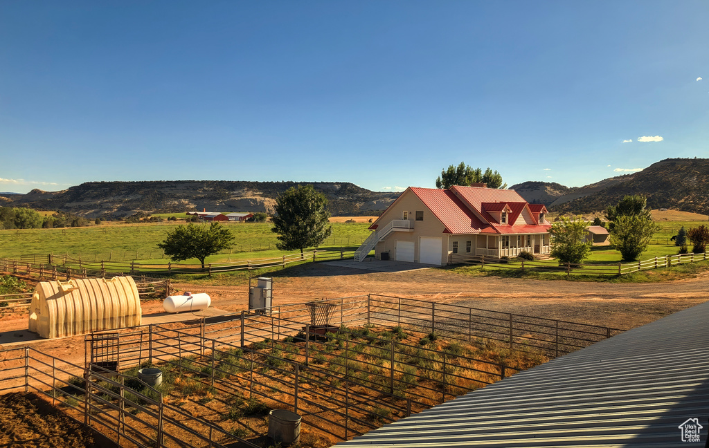 View of yard with a rural view, a mountain view, and driveway