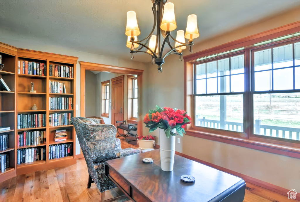 Dining area featuring an inviting chandelier, wood finished floors, and baseboards