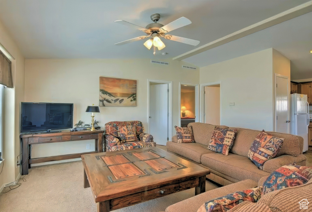 Living room featuring light carpet, ceiling fan, lofted ceiling, and visible vents