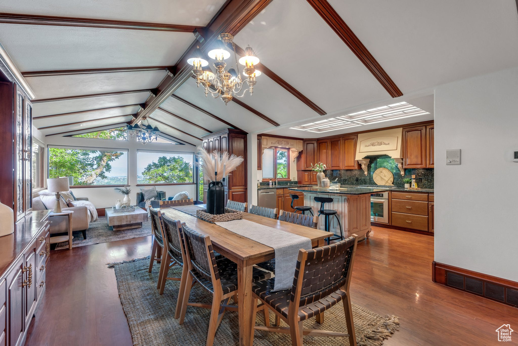 Dining area featuring a chandelier and dark wood finished floors