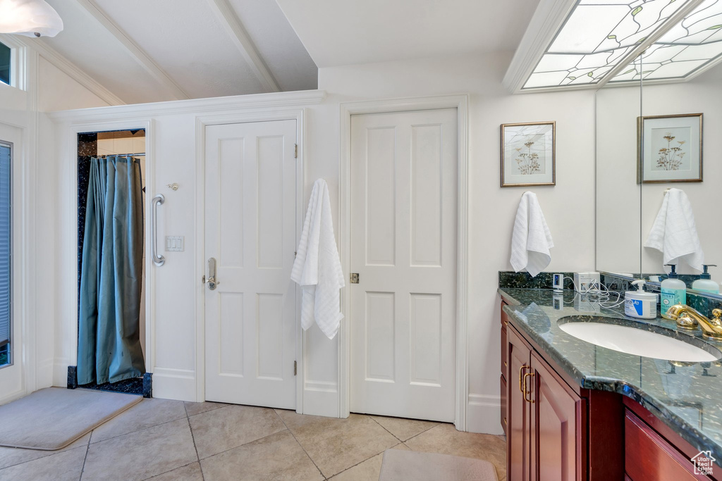 Full bathroom with tile patterned floors, vanity, and a shower with curtain
