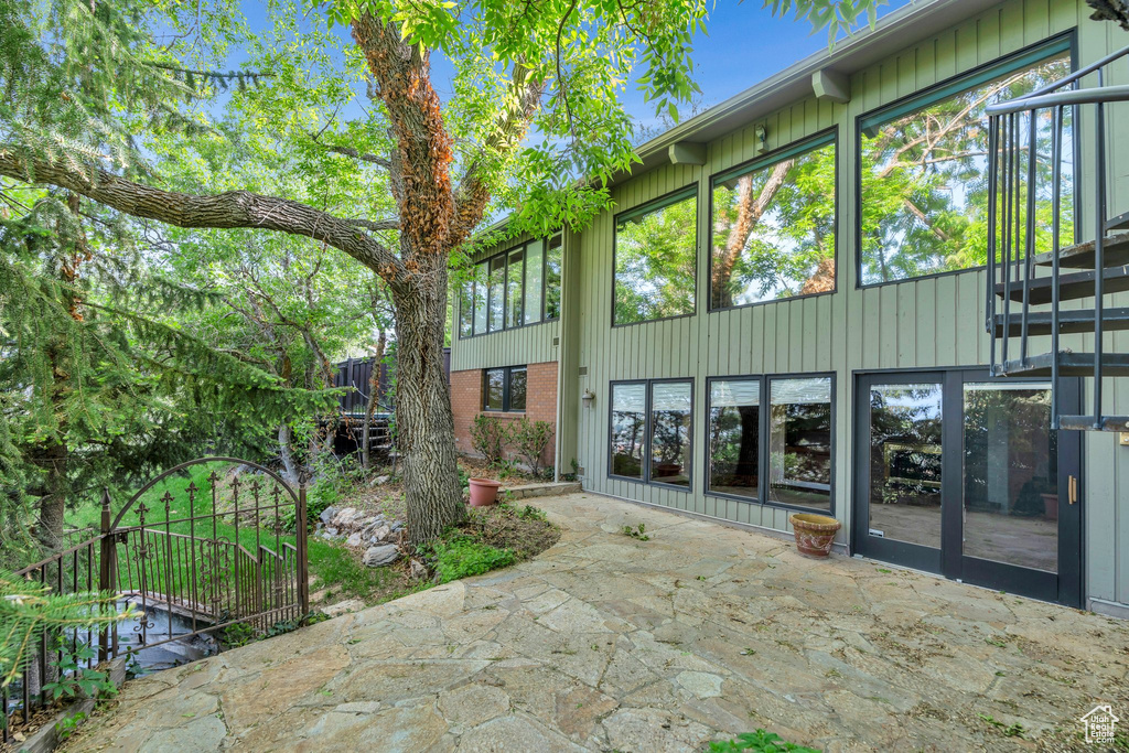 Back of property with a patio and stairway
