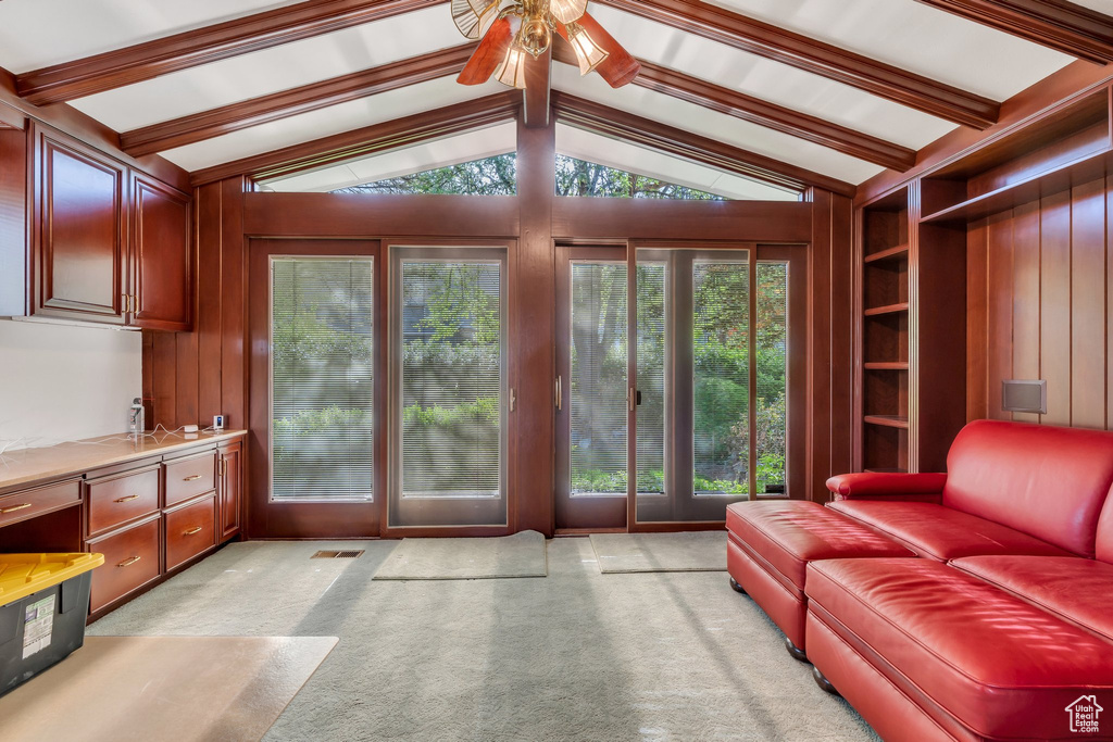 Living room with ceiling fan and light colored carpet