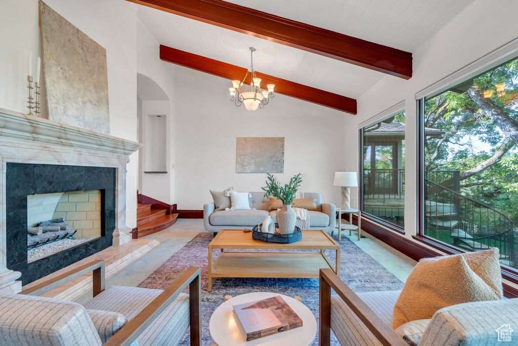 Living area with a chandelier, a fireplace, and arched walkways